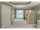 Bathroom featuring a soaking tub, a glass-door shower and a decorative window at 935 Brookline Way, Alpharetta, GA 30022