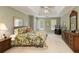 Bright bedroom featuring tray ceilings, neutral walls, carpet floors, and wooden furniture at 935 Brookline Way, Alpharetta, GA 30022