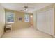 Bedroom showcasing windows with blinds, white closet doors, and beige carpet floors at 935 Brookline Way, Alpharetta, GA 30022