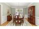 Formal dining room featuring hardwood floors, wainscoting, chandelier, and a large wooden dining table with seating at 935 Brookline Way, Alpharetta, GA 30022