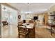 Spacious dining room with hardwood floors, pendant lighting, and adjacent kitchen and sunroom for comfortable living at 935 Brookline Way, Alpharetta, GA 30022