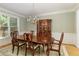 Elegant dining room featuring a wooden table with upholstered chairs and a beautiful chandelier with natural light at 935 Brookline Way, Alpharetta, GA 30022