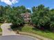 Beautiful brick home with manicured lawn, mature trees, and a circular driveway, creating a welcoming curb appeal at 935 Brookline Way, Alpharetta, GA 30022