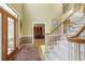Grand foyer featuring hardwood floors, high ceilings, and a staircase with carpeted steps and white railings at 935 Brookline Way, Alpharetta, GA 30022