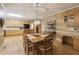 Open kitchen and dining area featuring natural wood cabinetry, built-in appliances, and hardwood floors at 935 Brookline Way, Alpharetta, GA 30022