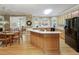 Eat-in kitchen with wood cabinets, long island, and plenty of natural light from an arched window at 935 Brookline Way, Alpharetta, GA 30022