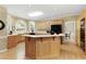 Bright kitchen features an island, lots of counter space, and black appliances at 935 Brookline Way, Alpharetta, GA 30022