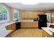 Classic kitchen with light wood cabinets, white countertops, and black appliances at 935 Brookline Way, Alpharetta, GA 30022