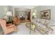 Cozy living room featuring a floral sofa, wingback chairs, and an open view to the dining area at 935 Brookline Way, Alpharetta, GA 30022