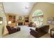 Spacious living room with a high vaulted ceiling, fireplace, built-in shelves, and oversized window at 935 Brookline Way, Alpharetta, GA 30022