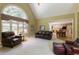 Inviting living room featuring a fireplace, built-in shelving, and access to the kitchen at 935 Brookline Way, Alpharetta, GA 30022