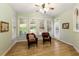 Bright sunroom with multiple windows, light green walls, hardwood floors, and comfortable seating at 935 Brookline Way, Alpharetta, GA 30022