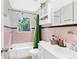 Well-lit bathroom with a shower/tub combo, white vanity, and pink tile at 1091 Napier Se St, Atlanta, GA 30316