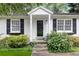 Charming front door with white trim and black shutters surrounded by lush landscaping at 1091 Napier Se St, Atlanta, GA 30316