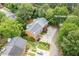 Bird's eye view of home surrounded by mature trees; address 1995 Raleigh Tavern Dr at 1995 Raleigh Tavern Dr, Roswell, GA 30076