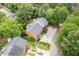 Aerial view of home with gray roof, spacious driveway and decorative landscaping at 1995 Raleigh Tavern Dr, Roswell, GA 30076