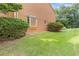 Exterior view of home with healthy green grass and natural decorative bushes at 1995 Raleigh Tavern Dr, Roswell, GA 30076