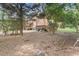 Backyard view with wooden deck and stairs with natural wooded surroundings at 1995 Raleigh Tavern Dr, Roswell, GA 30076