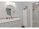 Well-lit bathroom with a marble countertop, decorative mirror and cabinet storage at 1995 Raleigh Tavern Dr, Roswell, GA 30076