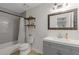 Cozy bathroom with modern vanity, framed mirror and shower-tub combination at 1995 Raleigh Tavern Dr, Roswell, GA 30076