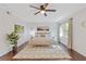 Bright bedroom with a neutral color scheme, large window, and stylish ceiling fan at 1995 Raleigh Tavern Dr, Roswell, GA 30076