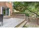 Cozy deck area surrounded by lush greenery and decorative wood railing at 1995 Raleigh Tavern Dr, Roswell, GA 30076