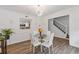 Modern dining area with hardwood floors, stylish lighting, and a view into the kitchen at 1995 Raleigh Tavern Dr, Roswell, GA 30076