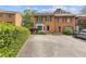 Charming brick townhome with black shutters and a well-manicured front yard at 1995 Raleigh Tavern Dr, Roswell, GA 30076