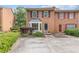 Charming brick townhome with black shutters and a well-manicured front yard at 1995 Raleigh Tavern Dr, Roswell, GA 30076