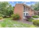 Charming brick townhome with black shutters and a well-manicured lawn at 1995 Raleigh Tavern Dr, Roswell, GA 30076