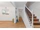 Inviting foyer with hardwood floors, stairs and neutral paint at 1995 Raleigh Tavern Dr, Roswell, GA 30076