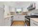 Updated kitchen with white cabinets, stainless steel appliances, and granite countertops at 1995 Raleigh Tavern Dr, Roswell, GA 30076