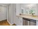 Galley kitchen with stainless steel dishwasher and granite counters overlooking sunny breakfast nook at 1995 Raleigh Tavern Dr, Roswell, GA 30076