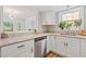 Modern kitchen featuring granite countertops, stainless steel appliances and white cabinetry at 1995 Raleigh Tavern Dr, Roswell, GA 30076