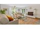 Inviting living room with white brick fireplace, and sliding glass doors to backyard deck at 1995 Raleigh Tavern Dr, Roswell, GA 30076