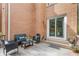 Charming brick patio with cozy seating area, sliding glass doors and a natural wood deck at 1995 Raleigh Tavern Dr, Roswell, GA 30076
