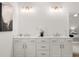 Bright bathroom with a double sink vanity, modern lighting, and ample cabinet space for storage at 210 Sharon Ln, Loganville, GA 30052