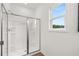 Modern bathroom featuring glass-enclosed shower with bright natural light and fixtures at 210 Sharon Ln, Loganville, GA 30052