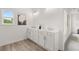 Elegant bathroom with double vanity, white cabinets, and sleek fixtures for a modern, clean design at 210 Sharon Ln, Loganville, GA 30052