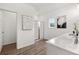 Bright bathroom features glass shower, hard wood floor and white walls at 210 Sharon Ln, Loganville, GA 30052