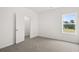 Light-filled bedroom with plush carpeting, large window and closet at 210 Sharon Ln, Loganville, GA 30052