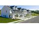 Charming townhomes featuring two-car garages, craftsman-style architectural details, and landscaping at 210 Sharon Ln, Loganville, GA 30052