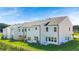 Rear view of newly constructed townhomes with white siding and well-maintained lawns at 210 Sharon Ln, Loganville, GA 30052