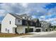 Charming townhome exteriors showcasing white siding, dark trim, and garage at 210 Sharon Ln, Loganville, GA 30052