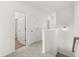 Bright hallway featuring an attic access point and open doors leading to other rooms at 210 Sharon Ln, Loganville, GA 30052