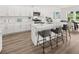 Contemporary kitchen with an island, white cabinets, stainless appliances, and bar stool seating at 210 Sharon Ln, Loganville, GA 30052