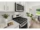 Modern kitchen with stainless steel range, white cabinets, and stylish decor at 210 Sharon Ln, Loganville, GA 30052
