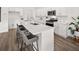 Modern kitchen island with quartz countertop, stainless steel sink, and bar stool seating at 210 Sharon Ln, Loganville, GA 30052