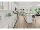 Spacious kitchen with stainless steel appliances, white cabinets, and views to the dining area at 210 Sharon Ln, Loganville, GA 30052