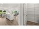 View of modern kitchen and walk-in pantry with wood-look flooring and white cabinets at 210 Sharon Ln, Loganville, GA 30052